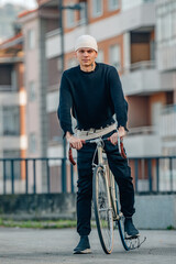 Wall Mural - urban young man with bicycle on the street