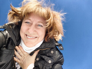 Smiling Woman on a Sunny Spring, Winter or early autumn Day Outdoors on nature