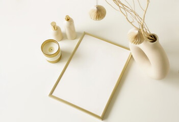 Wall Mural - Gold frame mockup and decor top view on white table.  Christmas, New Year elegant aesthetic home design.Minimalism. Copy space