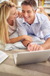 © ArcursForPI/peopleimages.com - Laptop, laughing and mature couple in home planning vacation with online budget together. Relax, computer and man and woman booking hotel, plant ticket or accommodation for holiday or weekend trip.
