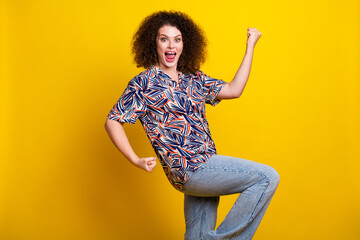 Sticker - Photo portrait of pretty young girl winning raise fists celebrate wear trendy colorful outfit isolated on yellow color background