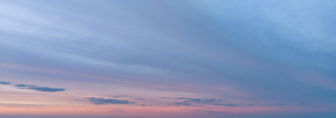 Beautiful sunset sky filled with soft pastel colors: pink, blue, and lavender, creating a serene atmosphere perfect for relaxation and reflection.