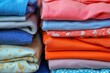 © Vlad - Folded Shirts Displayed on Table: Neatly Stacked Clothing for Home Organization