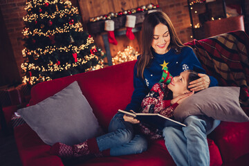 Sticker - Portrait of two people mother daughter hold book cuddle speak sofa festive christmas time illumination flat indoors