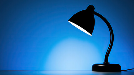 Wall Mural - silhouette of a table lamp in blue light background 