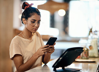 Poster - Coffee shop, online order and phone with store owner woman at counter for management of small business. App, contact and social media with startup employee in cafe or restaurant as entrepreneur