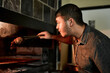 © HockleyM4/peopleimages.com - Man, meat and grill for barbecue, celebration and event on weekend or holiday with fireplace. Male person, cooking and bbq as food for nutrition, dinner and beef on flames in party, reunion or house