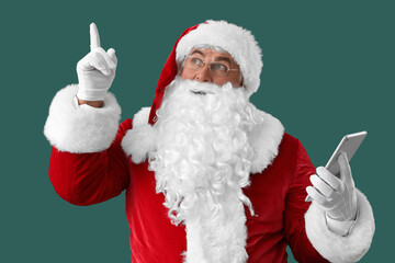 Sticker - Santa Claus with tablet computer pointing at something on green background