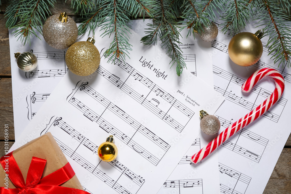 Composition with music sheets, Christmas decorations and fir branches on wooden background