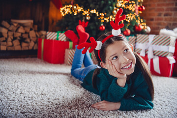 Poster - Full body photo of little girl lying floor look dreamy empty space wear christmas clothes cozy x-mas party decoration interior flat indoors