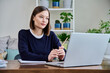 © Valerii Honcharuk - Young female college student studying using laptop computer for video chat