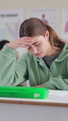 Aufkleber - Student, stress and writing exam with education, thinking and anxiety in classroom for scholarship. Female person, headache and high school in learning, development and academy for study or research