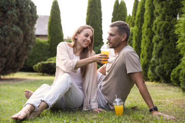 Wall Mural - Couple spending time together on green lawn in park