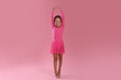 © New Africa - Little ballerina practicing dance moves on pink background
