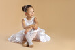 © New Africa - Portrait of little ballerina on beige background, space for text