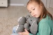 © New Africa - Autism concept. Lonely little girl with toy bunny at home