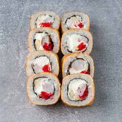 Wall Mural - Fried set of maki sushi rolls with shrimp, cream cheese and red flying fish caviar.