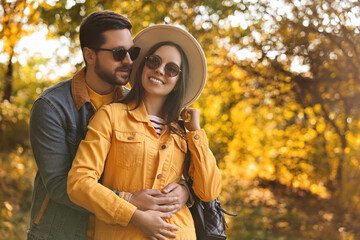 Poster - Beautiful couple hugging in park on autumn day, space for text