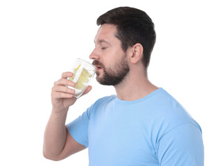 Sticker - Handsome man drinking water with lemon on white background