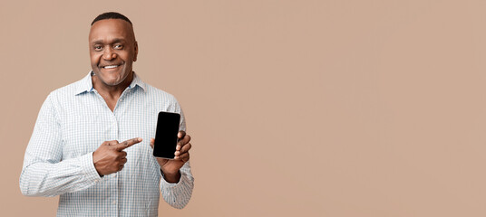 Awesome application or website. Middle aged black man showing blank cellphone screen, orange background with empty space