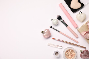 Poster - Different makeup brushes, decorative cosmetics and Christmas decor on white background, flat lay. Space for text