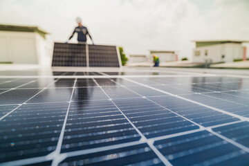 Wall Mural - a worker installs or maintains solar panels on a rooftop. the image highlights renewable energy tech