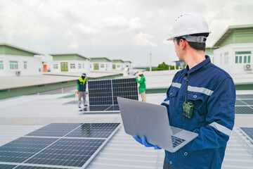 Wall Mural - a worker in protective gear uses a laptop while inspecting solar panels on a rooftop. the image emph