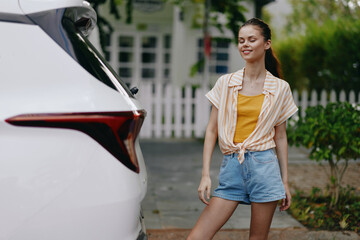 Young woman smiling near a car on a sunny day, wearing casual clothes, vibrant colors, urban background with greenery, showcasing a sense of freedom and lifestyle