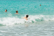 © Shmidt Vladilen - Boys swim in the turquoise sea during the summer holidays