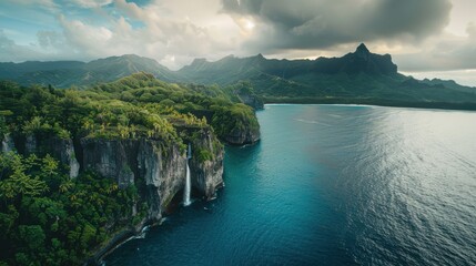 Aufkleber - A beautiful mountain range with a waterfall and a lake. The sky is cloudy, but the water is calm and clear