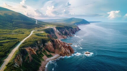 Aufkleber - The image captures a stunning view of the ocean and mountains, with a road running through the lush green hills in the distance. The sky is filled with fluffy clouds, creating a sense of calm