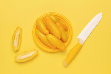 Bright Yellow Banana Peppers with Knife on Matching Background