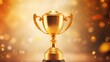© Tonton54 - Golden trophy on a sparkling background for award and achievement recognition.