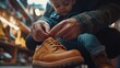 © vadosloginov - A shoe seller carefully fitting a child's shoe with warm family lighting in a cozy store setting