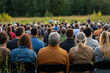 © Jiraphat.N - A front view of a public environmental awareness event, where speakers educate people about the importance of preserving natural ecosystems