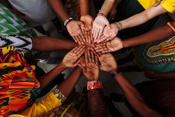 Wall Mural - Palms up hands of a group of multinational people: African, Latin American and European people which stay together in a circle.