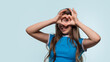 © Vagengeim - Girl creating heart shape with hands while smiling