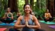 © maesarin - Peaceful and Relaxing Group Yoga Session Outdoors in a Lush Tranquil Forest Environment with Participants Performing Balanced Poses and Connecting with Nature