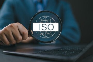 Poster - ISO standards quality control concept, Businessman using laptop with iso icon for assurance and warranty business technology.