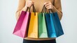 © Khritthithat - Joyful Shoppers with Colorful Shopping Bags