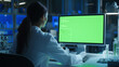 © Graphic Master - High-Tech Laboratory, Female Engineer in Lab Coat Working with Green Screen.