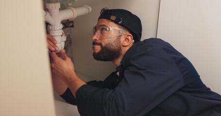 Plumber, man and pipe inspection in kitchen with safety for home maintenance or fixing leak by sink. Plumbing contractor, handyman and working on filter system improvement for small business in house