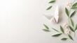 © Phirakhup - White origami butterfly with fresh green leaves and delicate flowers on a soft background.