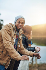 Wall Mural - Winter, friends and portrait of man in nature with smile, fun bonding and outdoor adventure together. Lake, happy face and group of people on pier for vacation, travel and relax on countryside bridge