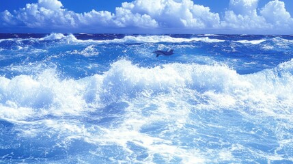 A dolphin leaps out of the water in a turquoise sea with whitecaps and a blue sky with clouds.