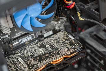 Fototapete - A close-up view of a computer's internal components highlighting the graphics card and cooling system during a routine check-up