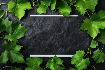 Sticker - A flat slate surface framed by vibrant green grape leaves, ideal for food presentation.