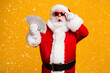 © deagreez - Portrait of his he nice attractive amazed astonished fat overweight bearded Santa holding in hand usd cash 100 hundred salary deposit isolated bright vivid shine vibrant yellow color background