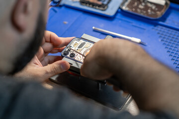 Aufkleber - A skilled technician focuses on replacing a phone battery, surrounded by tools and equipment in a vibrant workshop setting
