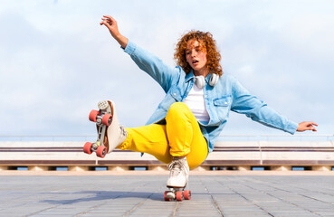 Beautiful red haired young woman with rollerskates having fun outdoors